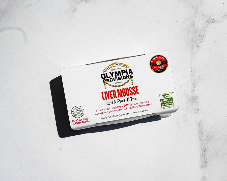 Olympia Provisions liver mousse packaging on a marble surface
