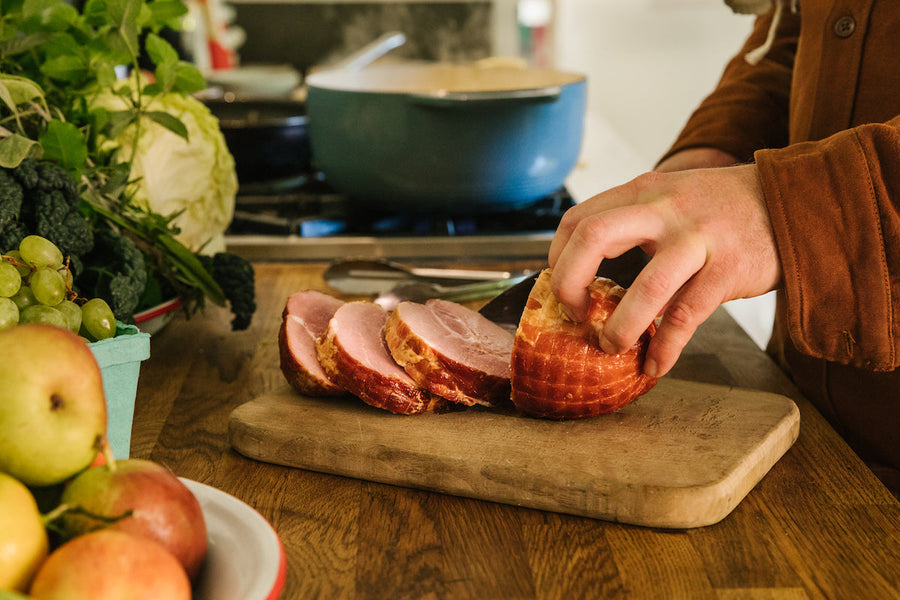Sliced ham on wood board