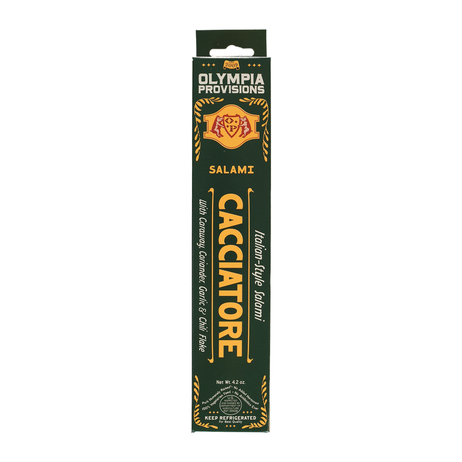 Olympia Provisions Salami Cacciatore with caraway, coriander, and chili flake, packaged in a green box.