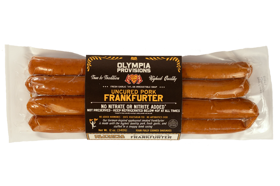 Olympia Provisions Uncured Pork Frankfurter with fresh garlic, in black packaging.