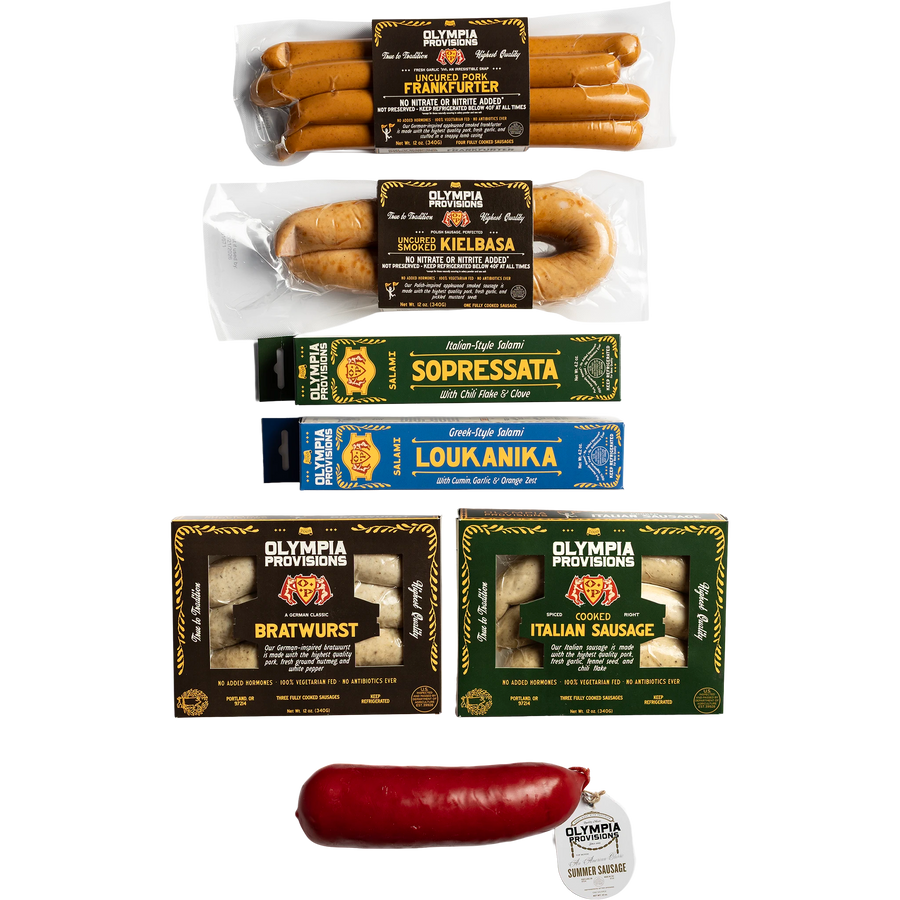 A collection of four Olympia Provisions sausages and two Olympia Provisions salamis, and one red Summer Sausage.