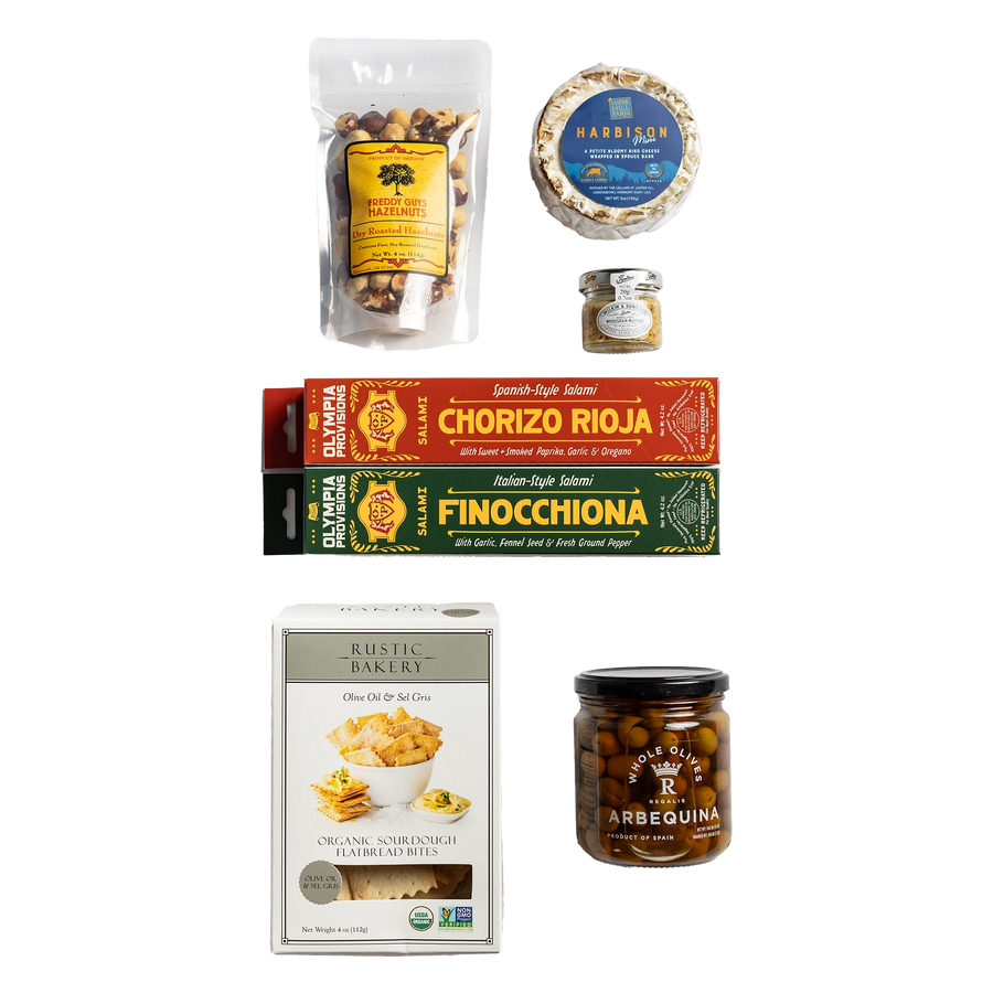 Two European-inspired Olympia Provisions salamis in boxes, Rustic Bakery crackers, Freddy guys hazelnuts, cheese, mustard, and olives.