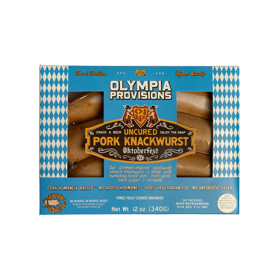 One pack of Olympia Provisions Knackwurst containing three links of sausage, packages in a blue box with white and blue diamond accents.