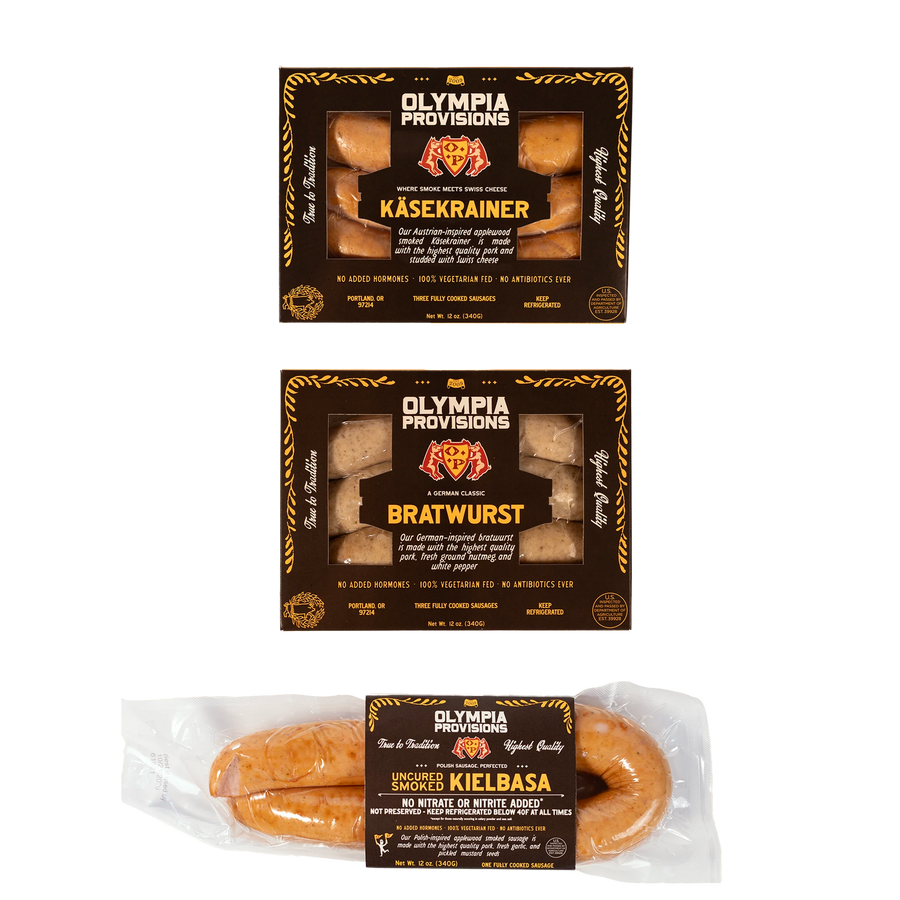 Olympia Provisions Kasekrainer, Bratwurst, and Kielbasa in black packaging.