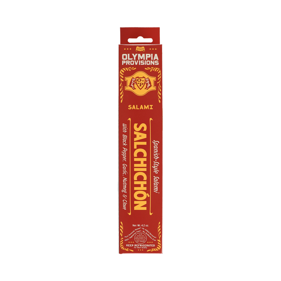 Olympia Provisions Spanish Salchichon with black pepper, garlic, nutmeg, and clove, packaged in a red box.