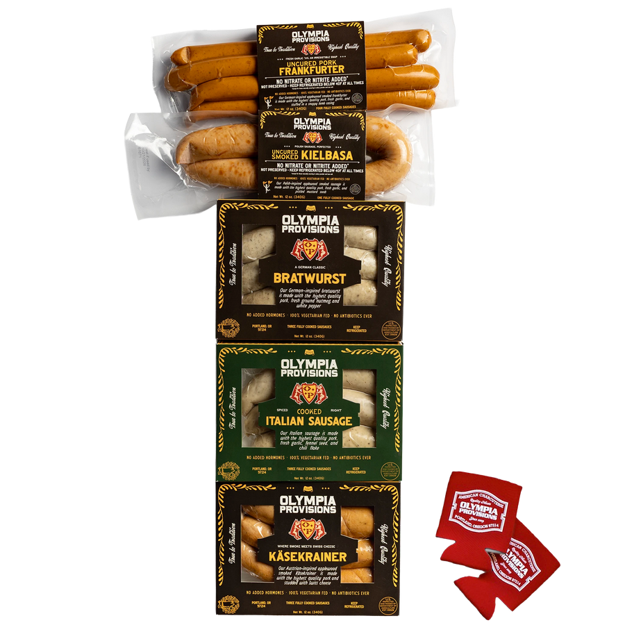 Five assorted Olympia Provisions sausages in black and green packaging, and two red Olympia Provisions coozies.
