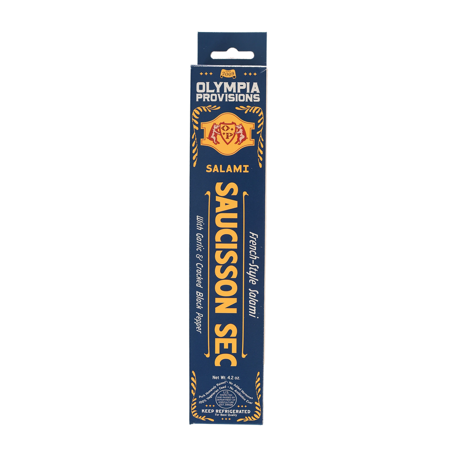 Olympia Provisions Saucisson Sec with garlic and black pepper, packaged in a blue box.